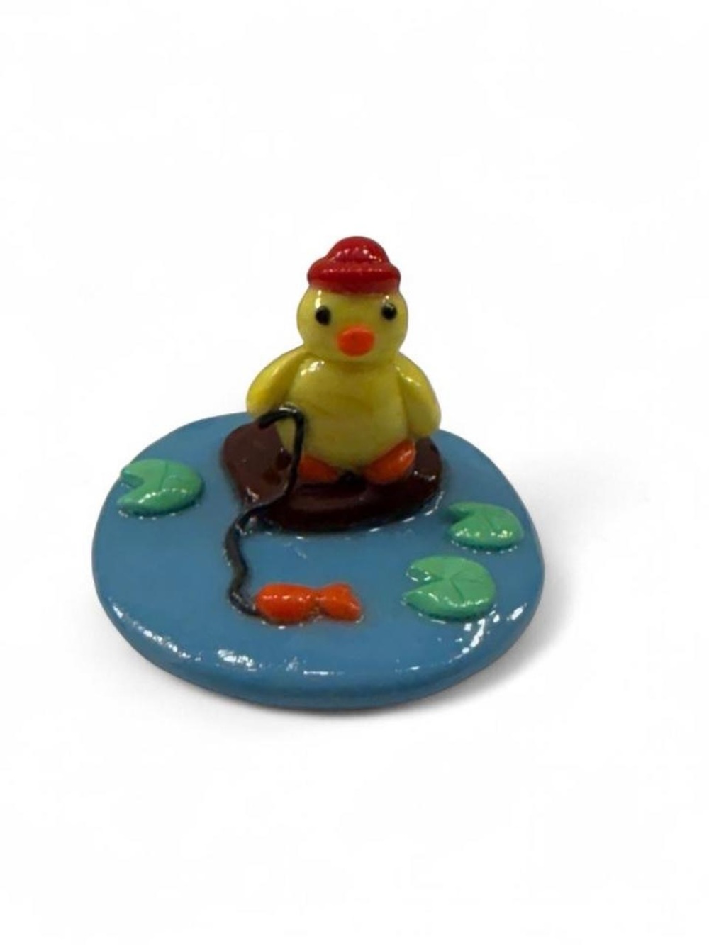 Cute Yellow Duck Figurine on Blue Pond